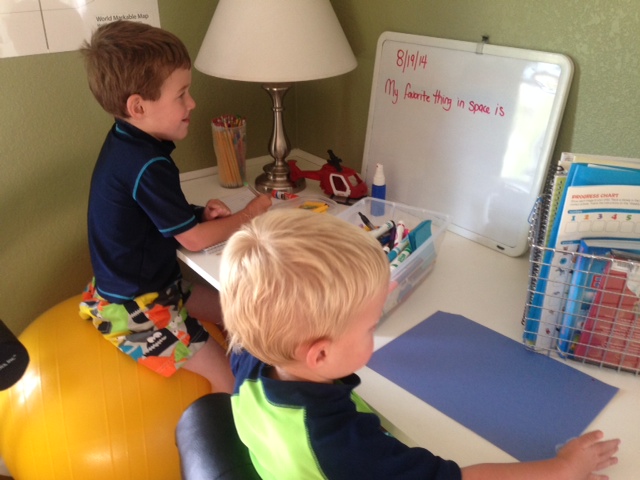 Both boys working on their "journal"