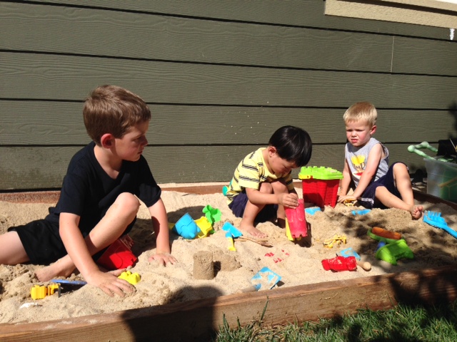 3 boys in the sandbox