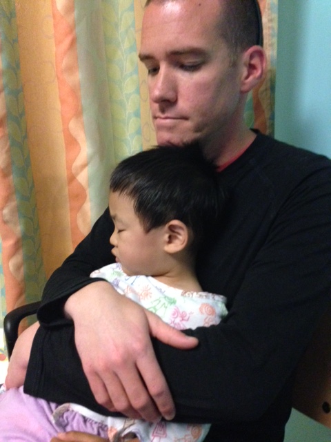 Sleeping on daddy's lap while we waited